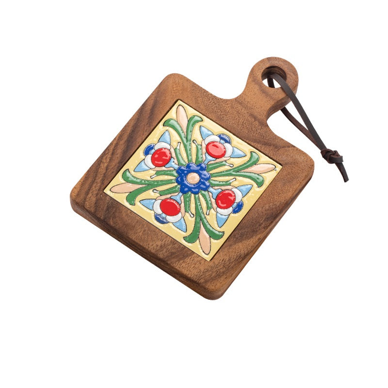 Wooden table mat with colorful floral ceramic tile and leather hanging loop