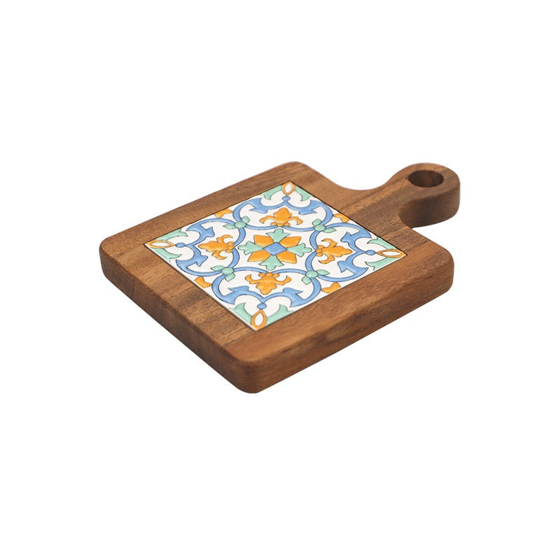 Side view of wood and ceramic table mat with orange and blue pattern