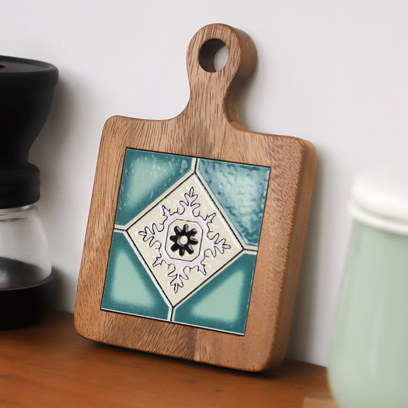 Close-up of turquoise ceramic and wood table mat on a shelf
