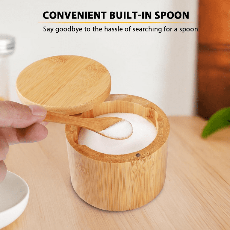 Hand using the built-in spoon from a bamboo seasoning jar filled with salt, with text overlay highlighting convenience